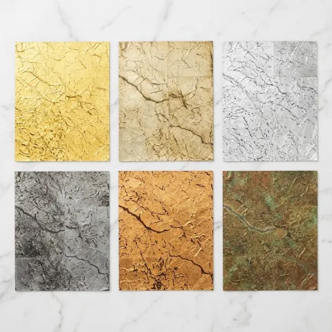 Six metallic leaf wallcovering swatches showing variations like bright gold, silver, copper, and oxidized pewter