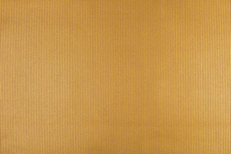 Close-up of Amber Cord yellow grasscloth wallpaper showing a tight plain paperweave grid in warm mustard amber with cream-white raised nodes at warp-weft intersections