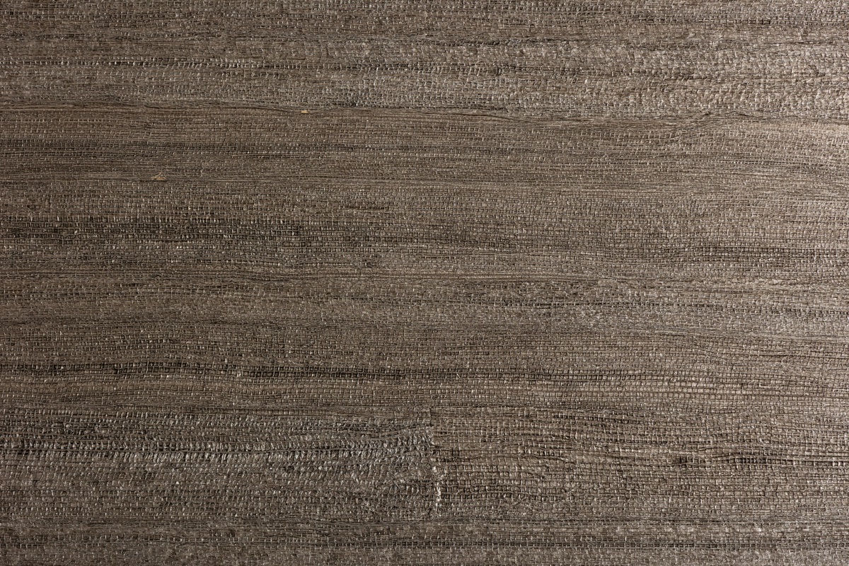 Close-up of real handwoven grasscloth wallpaper showing natural fibre texture and weave variation